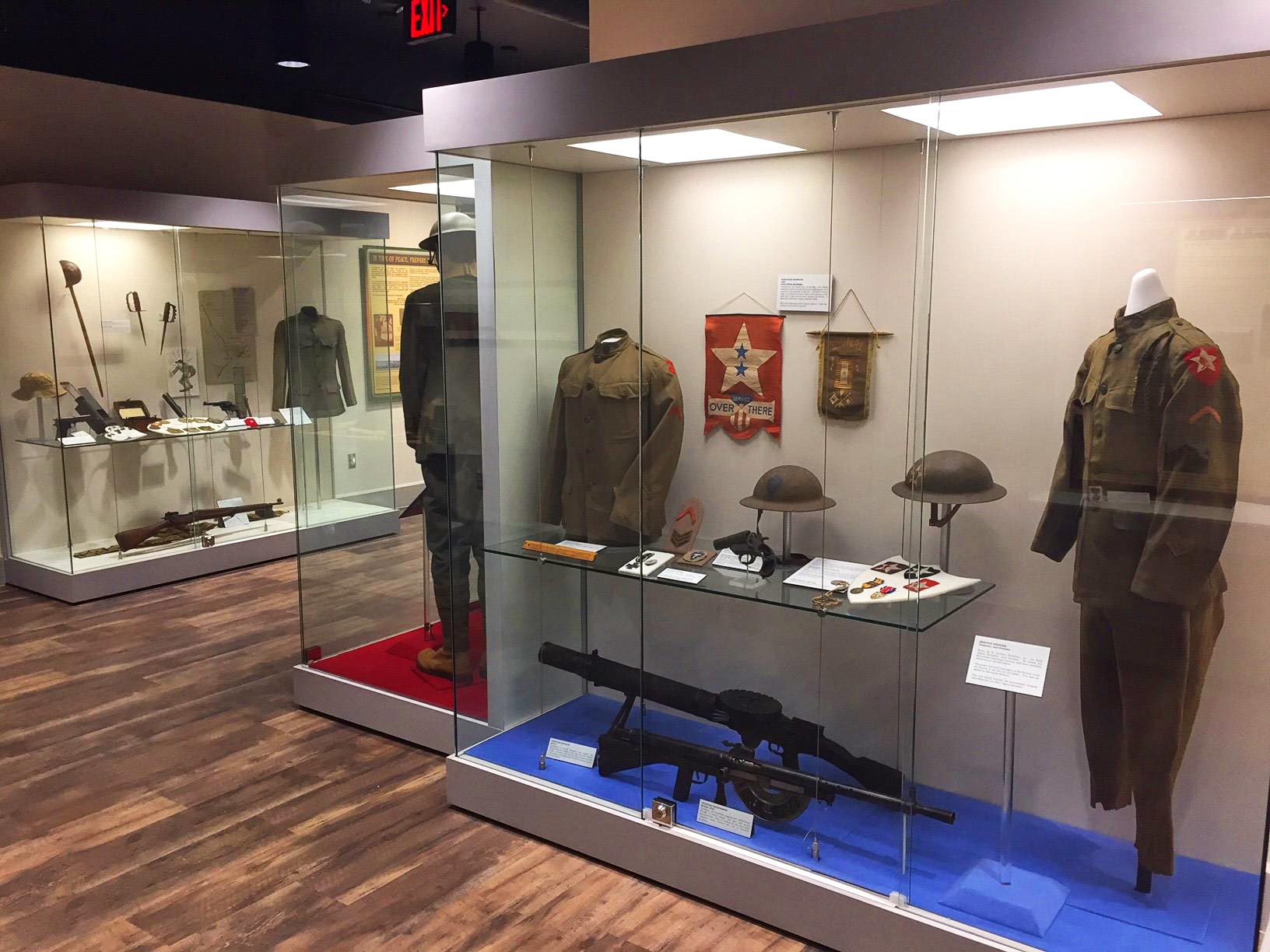 A museum exhibit featuring artifacts inside a glass enclosure at the Fort Sam Houston Museum.